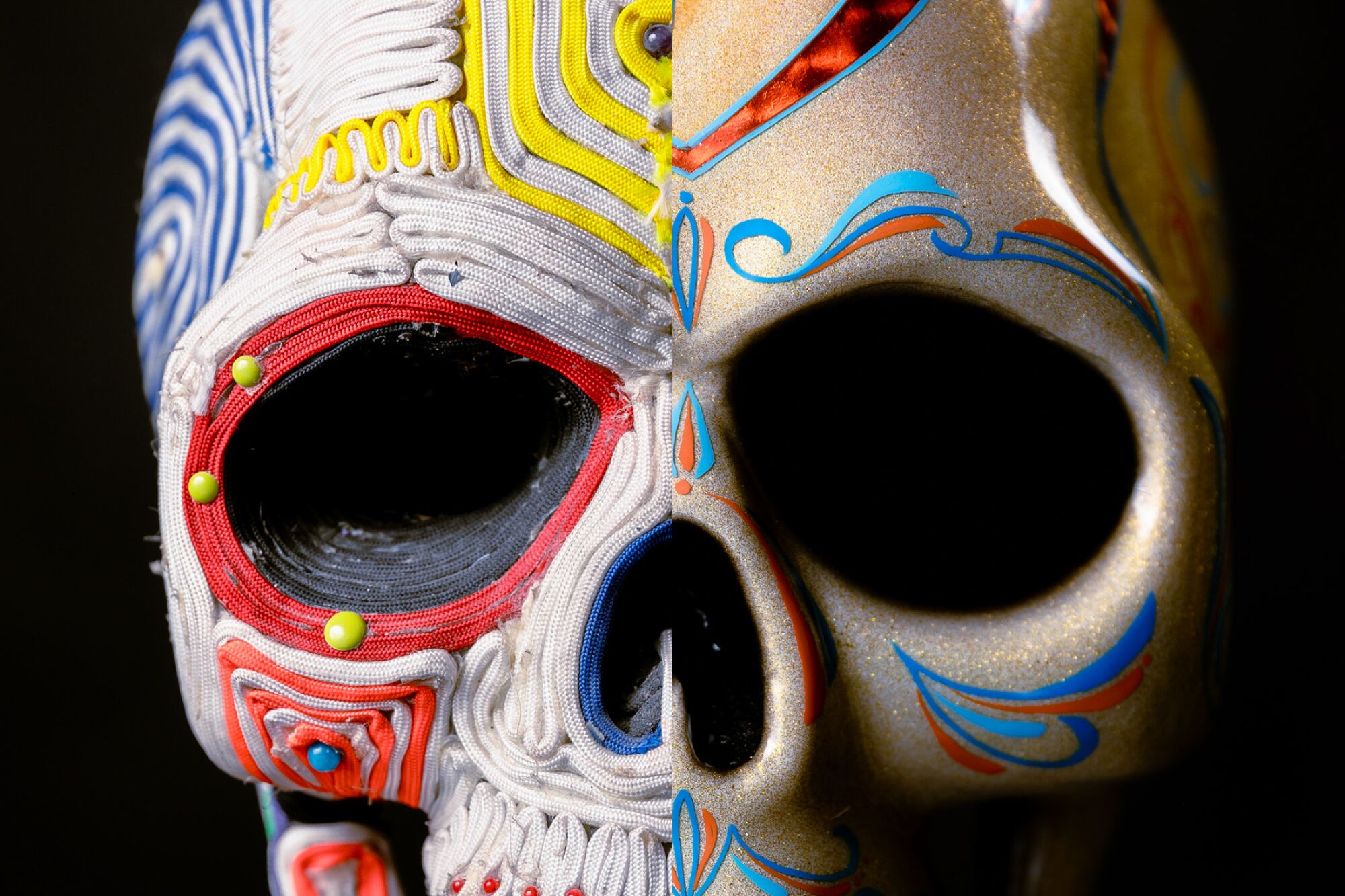 A skull mask made up of spliced photos of two different masks, one covered in fabric cording and one painted gold.