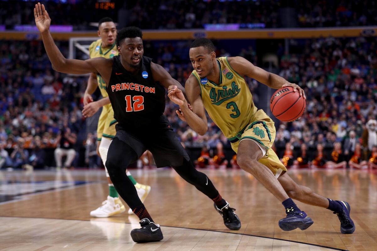 Notre Dame's V.J. Beachem drives to the basket against Princeton's Myles Stephens.