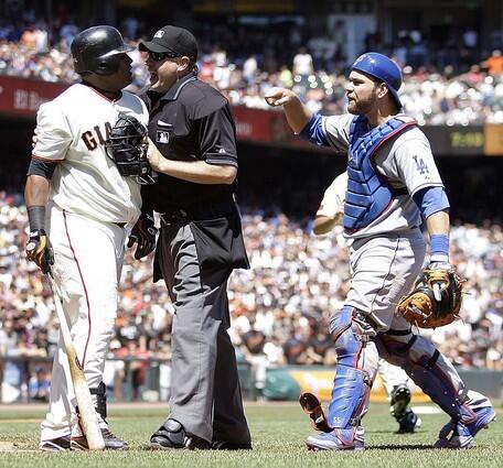 Dodgers catcher Russell Martin has some words for Giants third baseman Pablo Sandoval, who is restrained by home plate umpire Paul Emmel after he charged the mound in the fifth inning Wednesday.