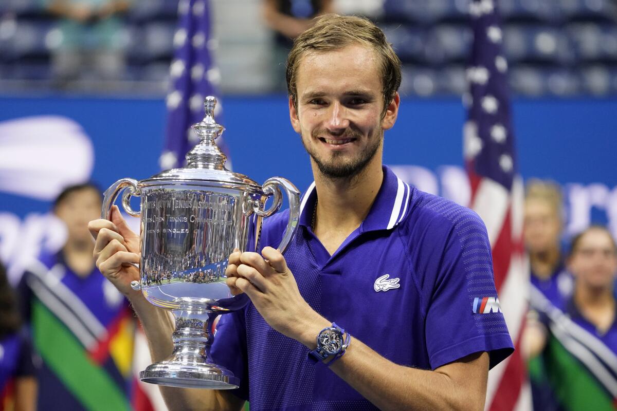 Daniil Medvedev holds the U.S. Open championship trophy after defeating Novak Djokovic on Sunday.