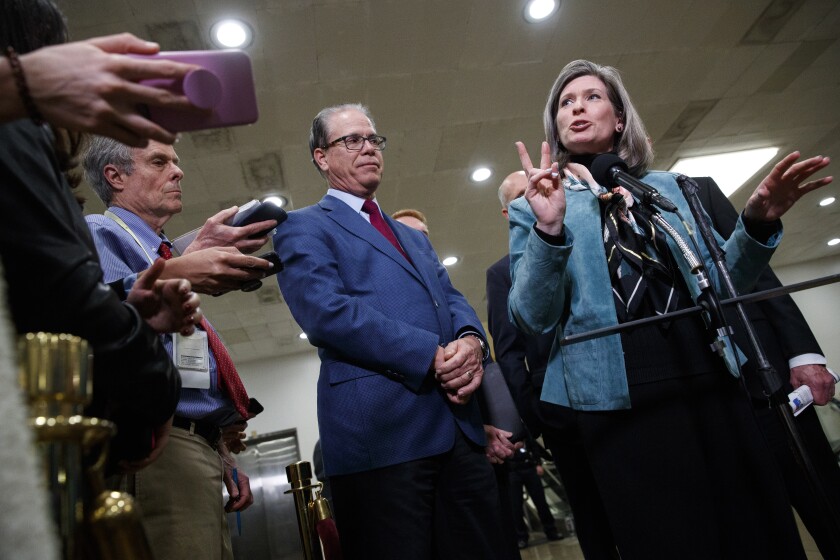 Sen. Joni Ernst (R-Iowa) speaks to the media in January on Capitol Hill as Sen. Mike Braun (R-Ind.) listens.