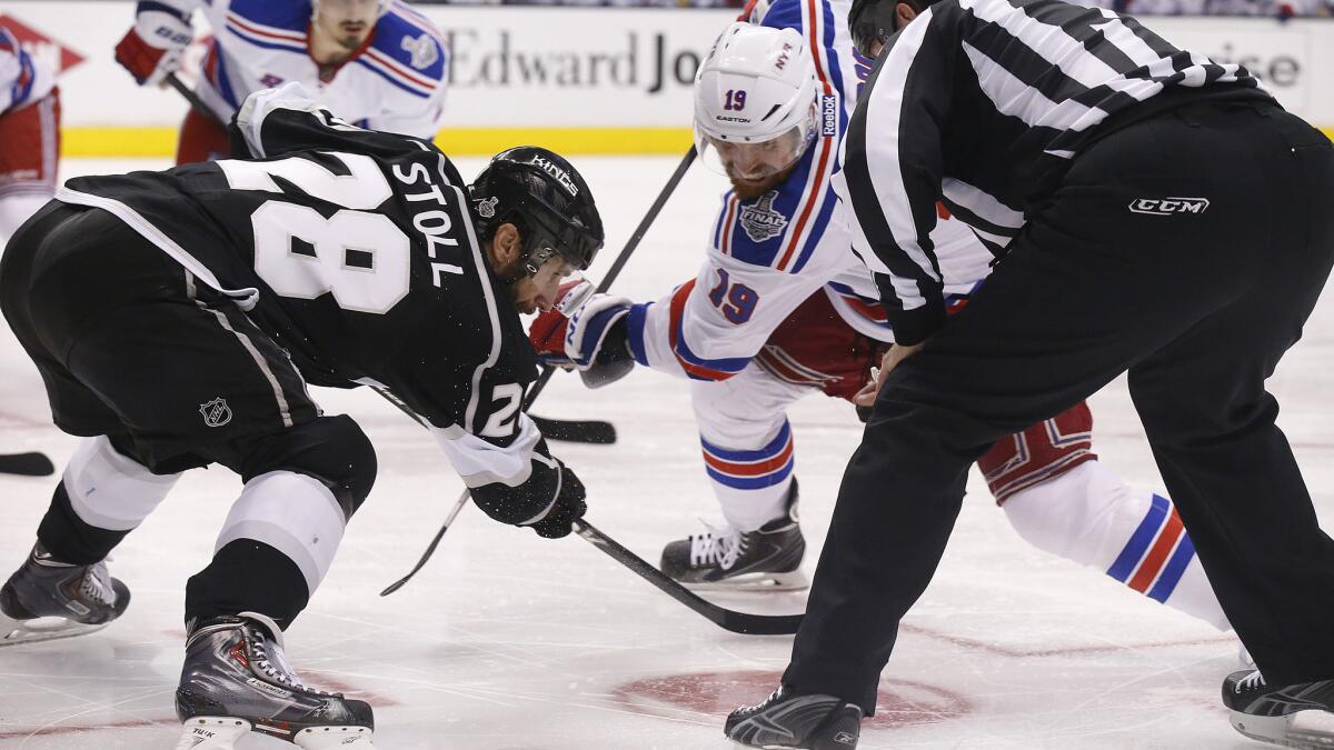 Kings center Jarret Stoll, left, faces off against New York Rangers center Brad Richards during the Kings' double-overtime win in Game 2 of the Stanley Cup Final at Staples Center on Saturday. Stoll is one of NHL's best at winning faceoffs.