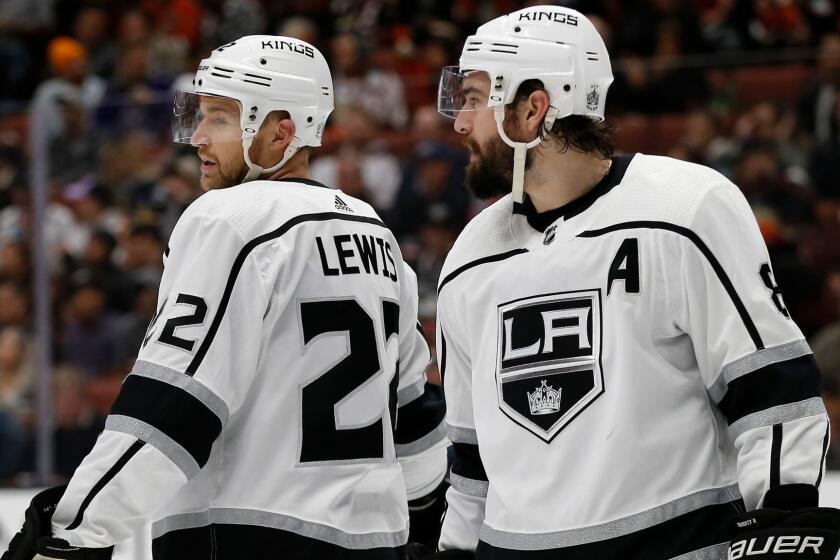 Los Angeles Kings center Trevor Lewis, left, talks with defenseman Drew Doughty during a time out in the second period of an NHL hockey game against the Anaheim Ducks in Anaheim, Calif., Friday, Jan. 19, 2018. (AP Photo/Alex Gallardo)