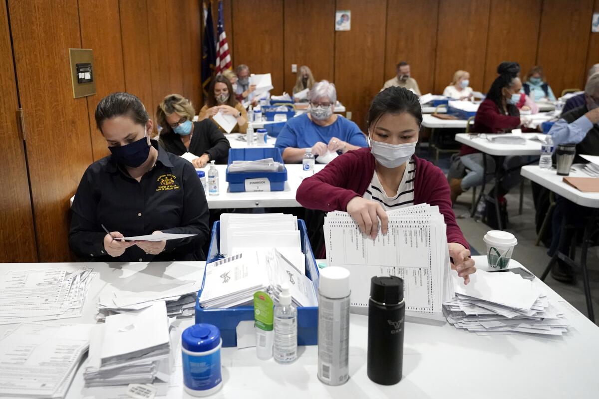Election workers in Harrisburg, Pa., sort and inspect ballots before they are counted on Tuesday.