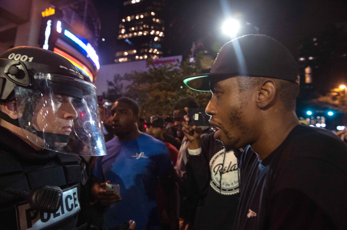 A policeman and a protester face to face.
