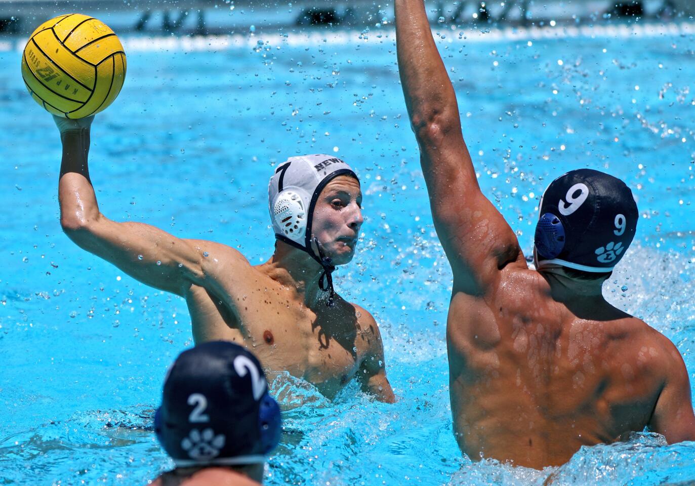 Newport Harbor High School water polo player Mason Hunt scores over the outstretched arms of Carson Kranz, right, in the championship game vs. Los Angeles Loyola at the Summer S & R Elite 8 Tournament at Harvard-Westlake High School, in Studio City on Saturday, July 13, 2019. Newport won 10-6.