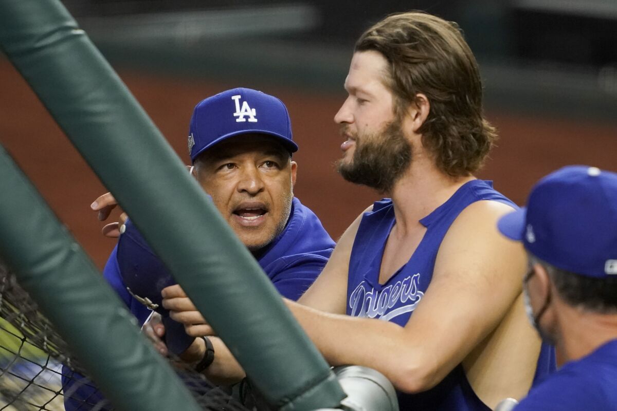 Dodgers manager Dave Roberts speaks with pitcher Clayton Kershaw.