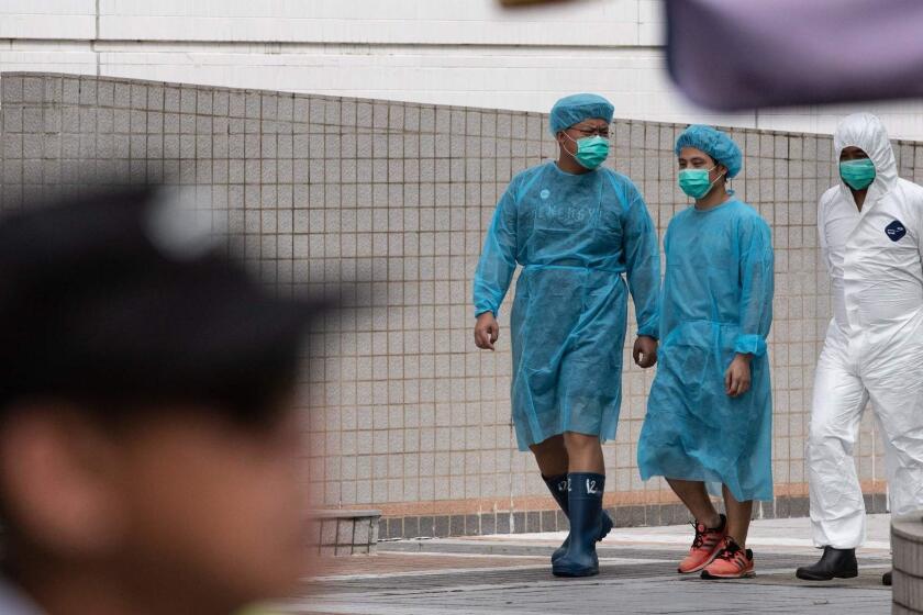 Staff members in protective gowns walk inside Sheung Shui slaughterhouse in Hong Kong on June 2, 2019. - Hong Kong starts culling 4,100 pigs from mainland China after African swine fever was detected in an animal at a slaughterhouse close to the border with China. (Photo by Philip FONG / AFP)PHILIP FONG/AFP/Getty Images ** OUTS - ELSENT, FPG, CM - OUTS * NM, PH, VA if sourced by CT, LA or MoD **