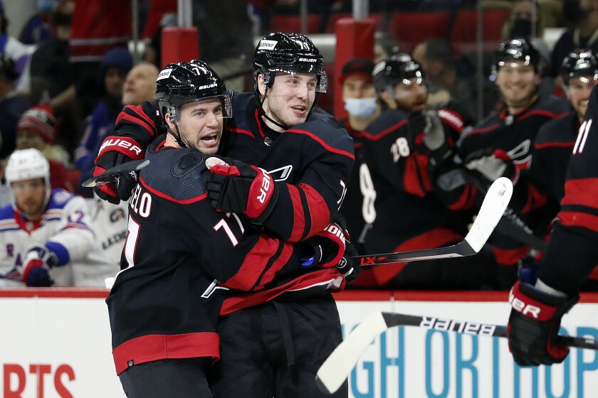 Carolina Hurricanes' Jesper Fast, right, celebrates his goal with teammate Tony DeAngelo (77) during the second period of an NHL hockey game against the New York Rangers in Raleigh, N.C., Friday, Jan. 21, 2022. (AP Photo/Karl B DeBlaker)