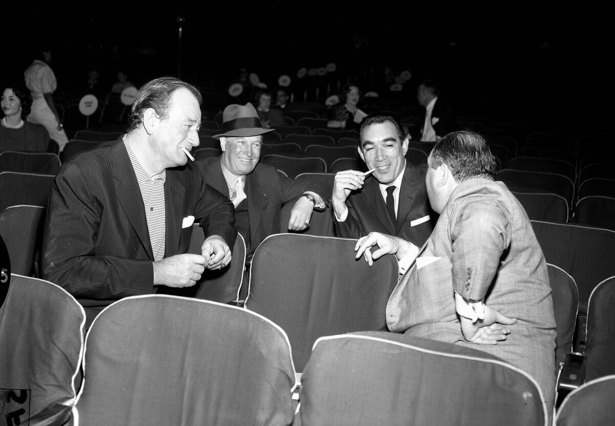 John Wayne, Maurice Chevalier, Anthony Quinn and Jerry Wald chat 