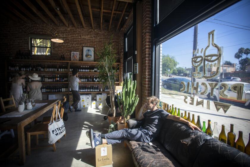 LOS ANGELES, CA AUGUST 31, 2019: Griffin Snyder relaxes on the sofa at Psychic Wines in Los Angeles, Ca August 31, 2019. (Francine Orr/ Los Angeles Times)