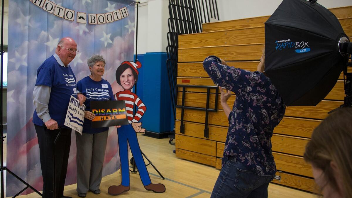 Charlie and Mary Leigh Blek of Trabuco Canyon with a cardboard cutout of Rep. Mimi Walters during a town hall meeting that Walters refused to attend at Northwood High School in Irvine.