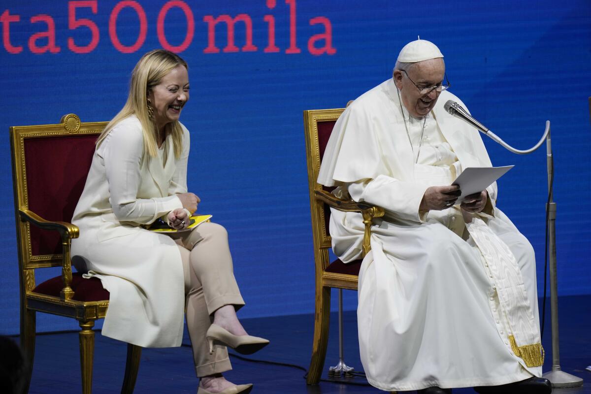 Pope Francis delivers his speech flanked by Italian Premier Giorgia Meloni 