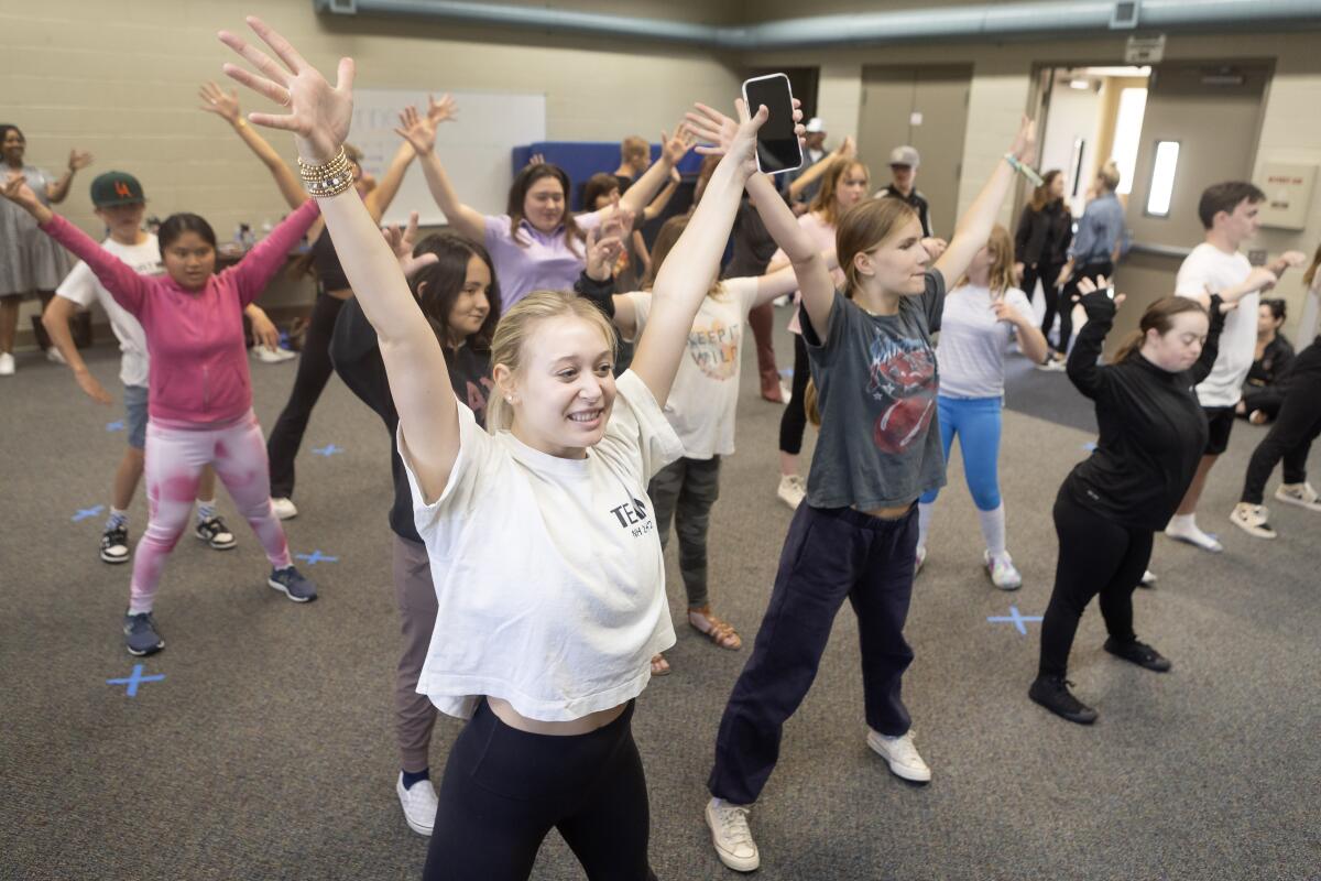 Newport Harbor's Chandler Green helps lead a dance class.