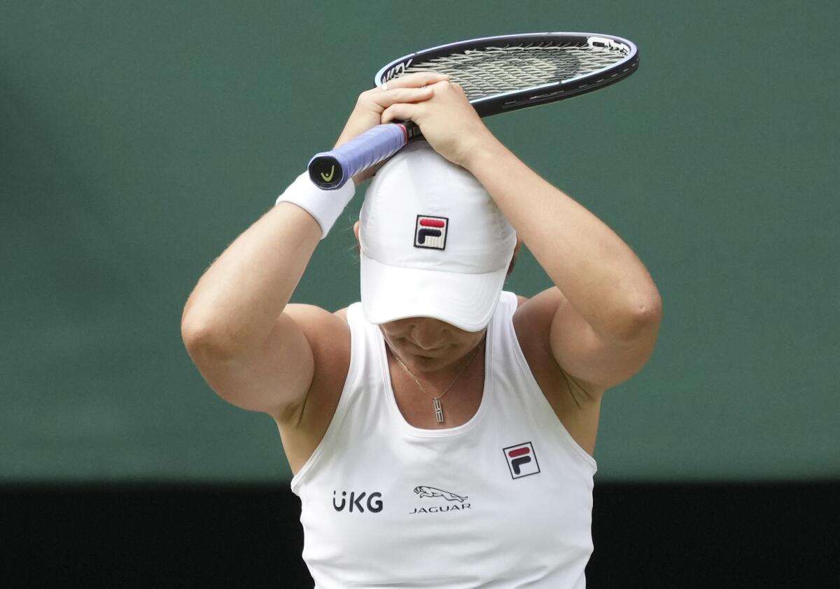 Australia's Ashleigh Barty celebrates after defeating Germany's Angelique Kerber in the women's singles semifinals match on day ten of the Wimbledon Tennis Championships in London, Thursday, July 8, 2021. (AP Photo/Alberto Pezzali)