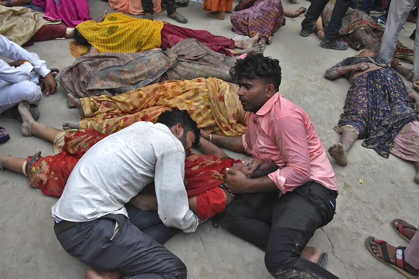 Relatives mourn next to the bodies of their relatives outside the Sikandrarao hospital in Hathras district about 350 kilometers (217 miles) southwest of Lucknow, India, Tuesday, July 2, 2024. A stampede among thousands of people at a religious gathering in northern India killed at least 60 and left scores injured, officials said Tuesday, adding that many women and children were among the dead and the toll could rise. (AP Photo)