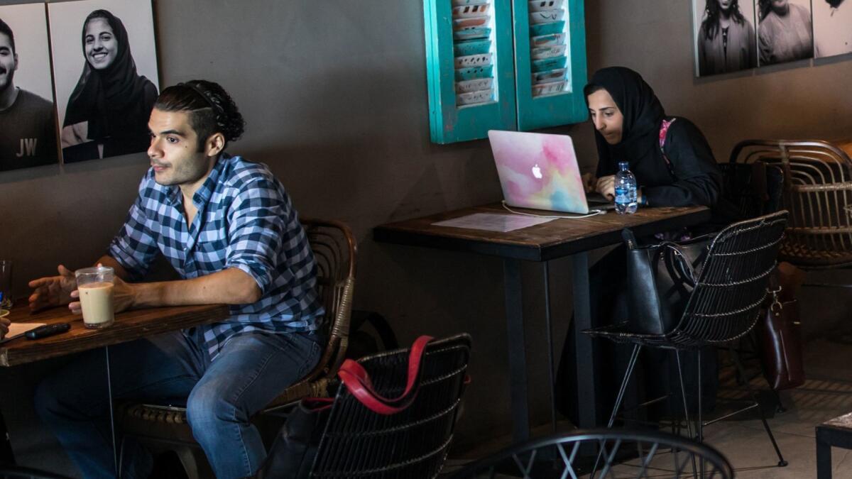Hakeem Jomah, left, who wrote the Saudi horror film “Madayen," at a cafe in Jidda that has become a gathering spot for the city's creative types.
