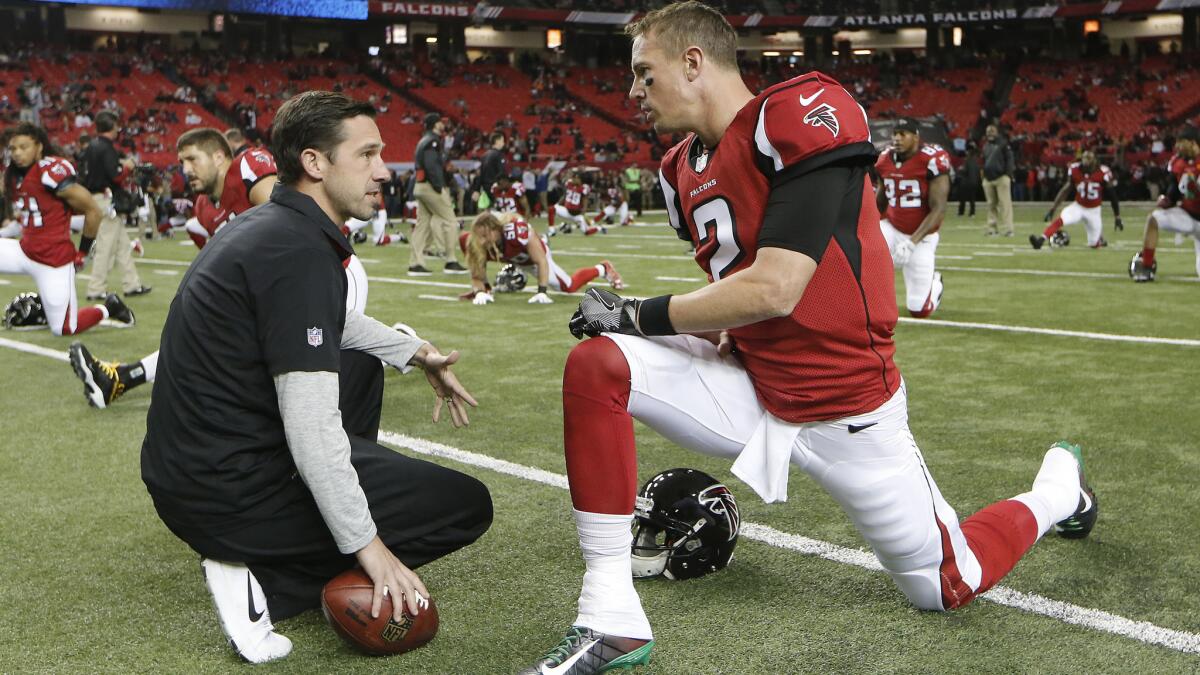 Falcons offensive coordinator Kyle Shanahan, shown chatting with quarterback Matt Ryan before a game against the Chiefs earlier this season, is the architect of the NFL’s highest-scoring offense.