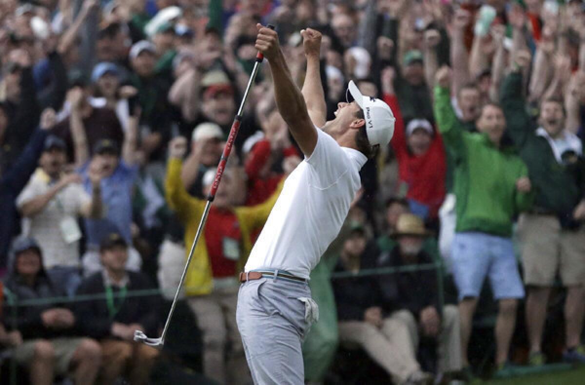 Adam Scott celebrates after making a birdie putt on the second playoff hole to win the Masters on Sunday.