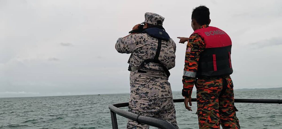 This photo released by Malaysian Maritime Enforcement Agency (MMEA) shows search and rescue operation for four foreign divers off the coast of Johor's Mersing, Malaysia Friday, April 8, 2022. Malaysian authorities resumed search for a third day Friday for three Europeans, including two teenagers, who disappeared while diving off a southern island.(Malaysian Maritime Enforcement Agency via AP )