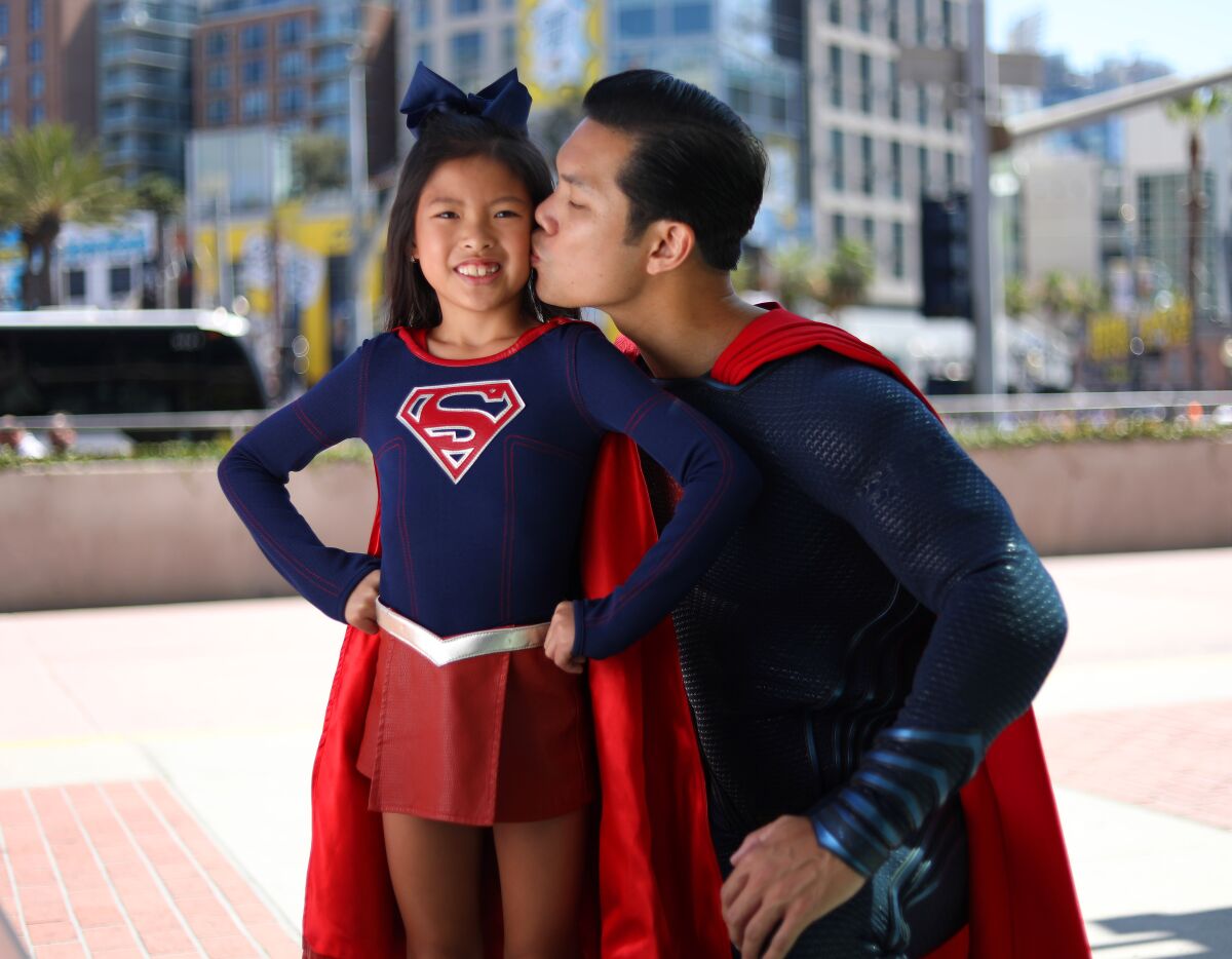 Bryan Nguyen of Irvine dressed as Superman with his daughter Kara as Supergirl at Comic-Con International in San Diego on July 20, 2019.