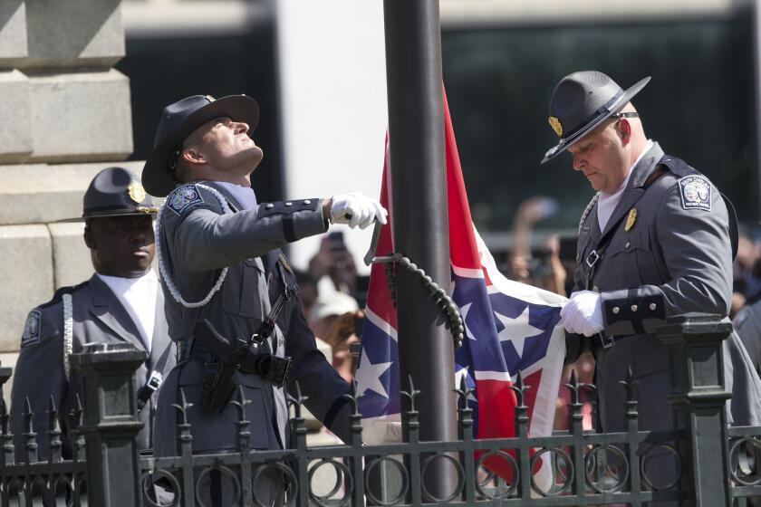 An honor guard from the South Carolina Highway Patrol removes the Confederate battle flag from the Capitol grounds.