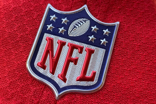 The official NFL logo is seen on the back of a hat.