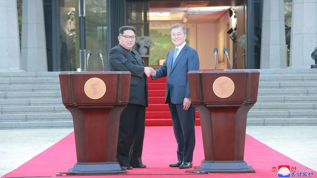 In a picture released by North Korea's state news agency, South Korean President Moon Jae-in and North Korea leader Kim Jong Un shake hands in the border village of Panmunjom on April 27.
