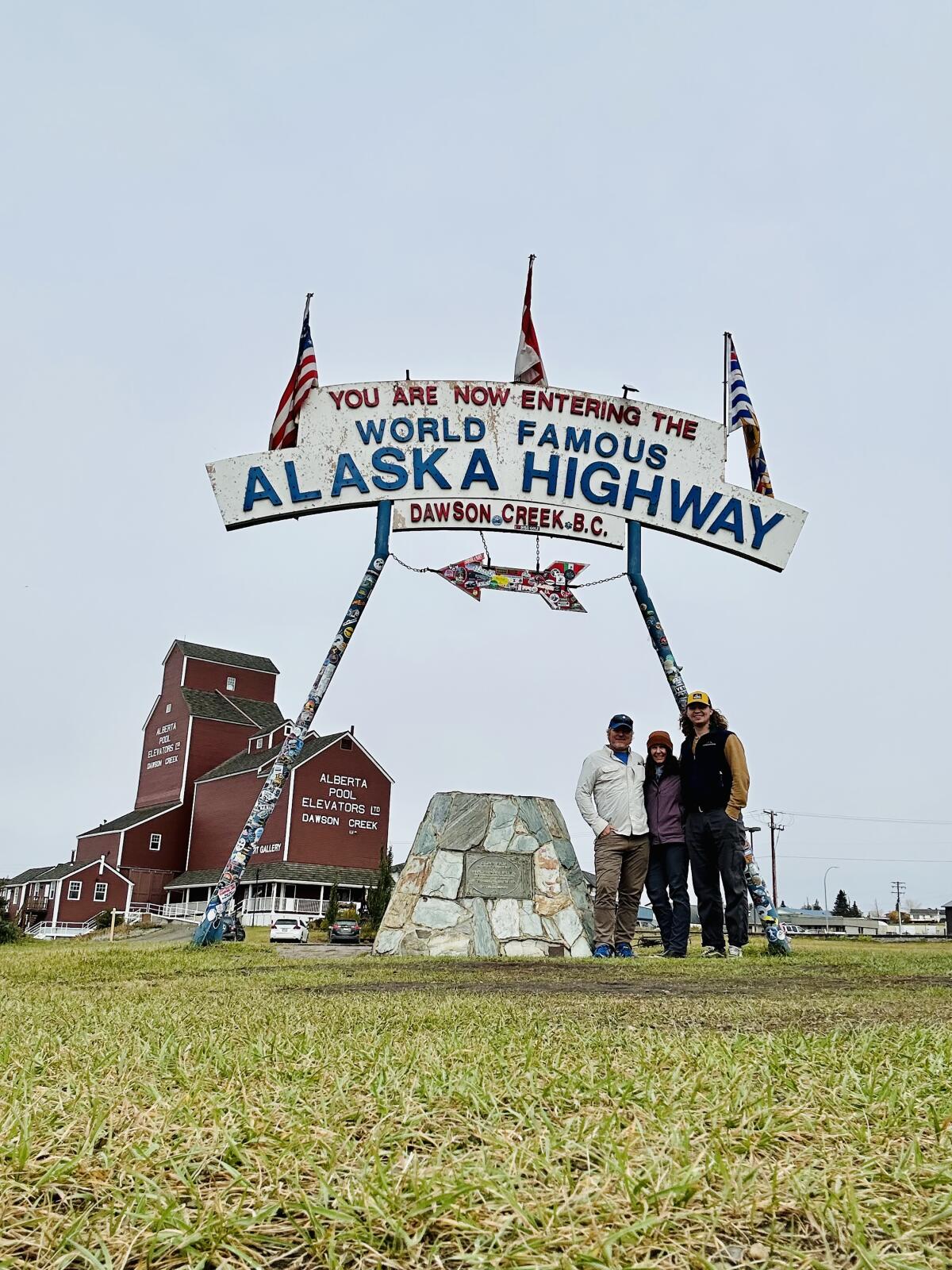 Elaine Glusac and her family at the Alaska Highway’s Mile Zero marker in Dawson Creek, British Columbia.
