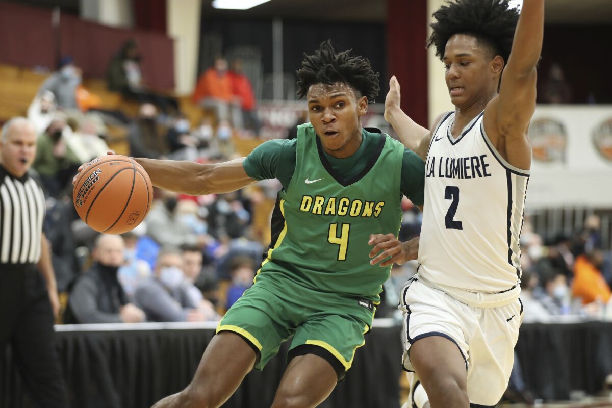 Dylan Andrews drives to the basket as another player defends during a game for Arizona Compass Prep.