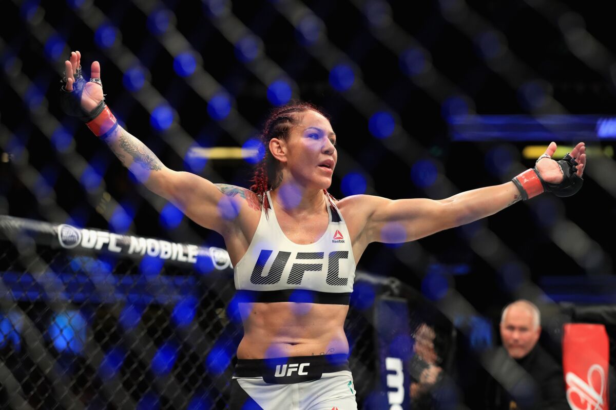 Cris "Cyborg" Justino celebrates after defeating Tonya Evinger in a featherweight title fight at UFC 214 in 2017.