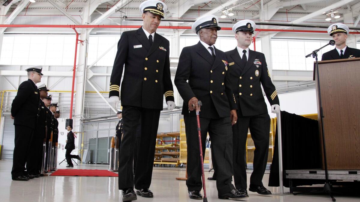 Carl Clark, center with cane, is escorted to a stage during a special presentation ceremony in 2012 at Moffett Field in Mountain View, Calif.