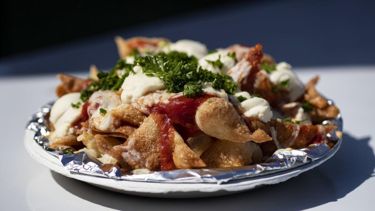 The usual rules don't apply to fair food. Here, lasagna nachos with marinara sauce, cheese and parsley.