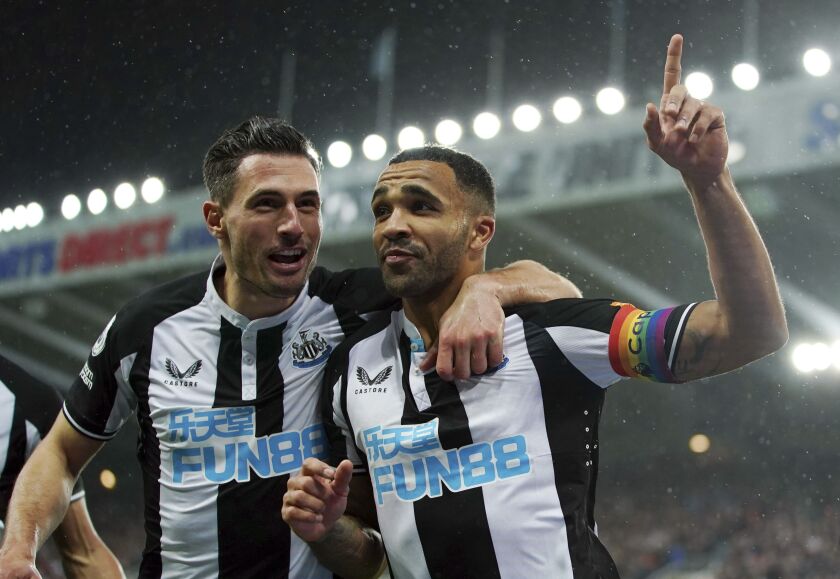 Newcastle United's Callum Wilson, right, celebrates scoring during the English Premier League soccer match between Newcastle United and Norwich City at St James' Park, Newcastle, England, Tuesday Nov. 30, 2021. (Mike Egerton/PA via AP)