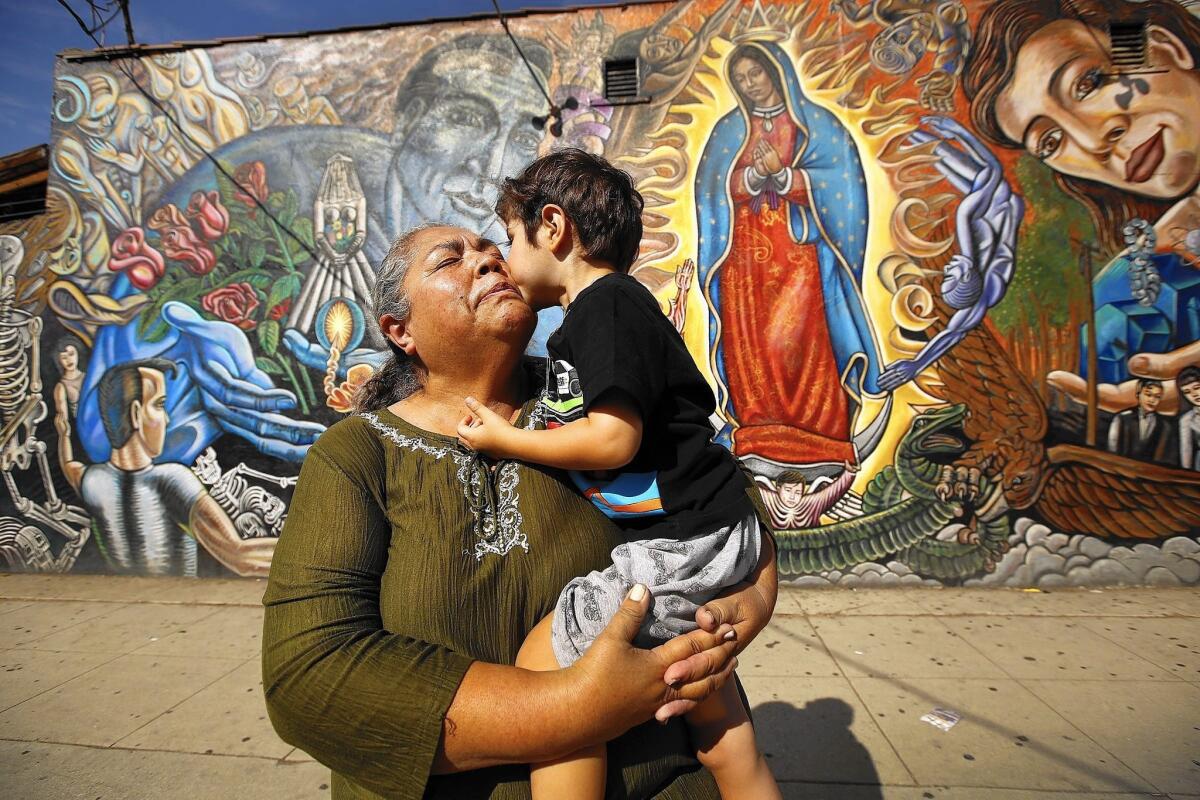 Rosa Manriquez kisses Matteo Arvizu, her 3-year-old grandson, in East Los Angeles. Matteo is the son of one of her two lesbian daughters. Manriquez will be traveling to Philadelphia for Pope Francis’ World Meeting of Families.