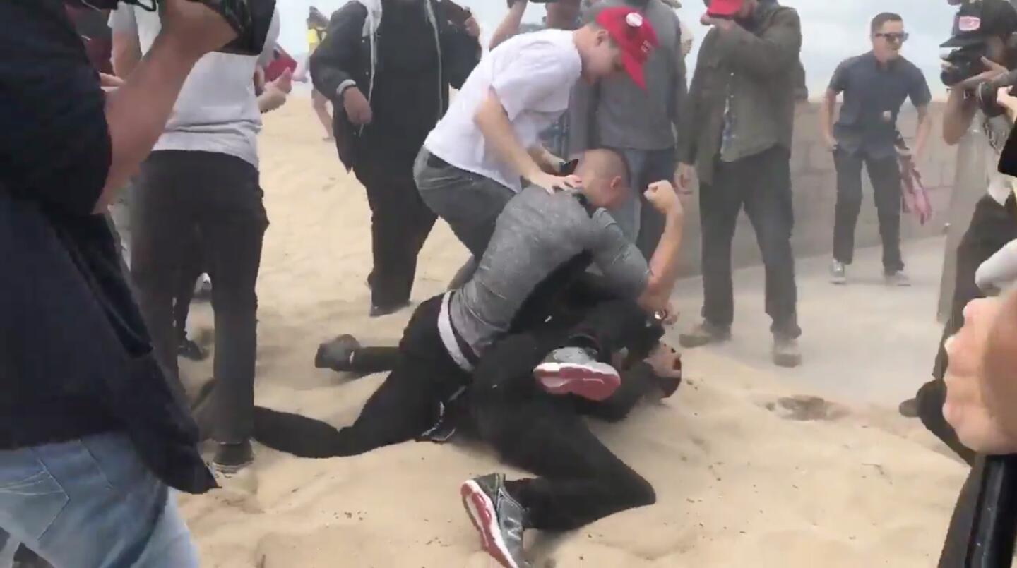Violence erupts at a Make America Great Again rally in Huntington Beach when a protester opposed to President Trump allegedly doused the organizer of the event with pepper spray and was immediately pummelled by a group of Trump supporters.