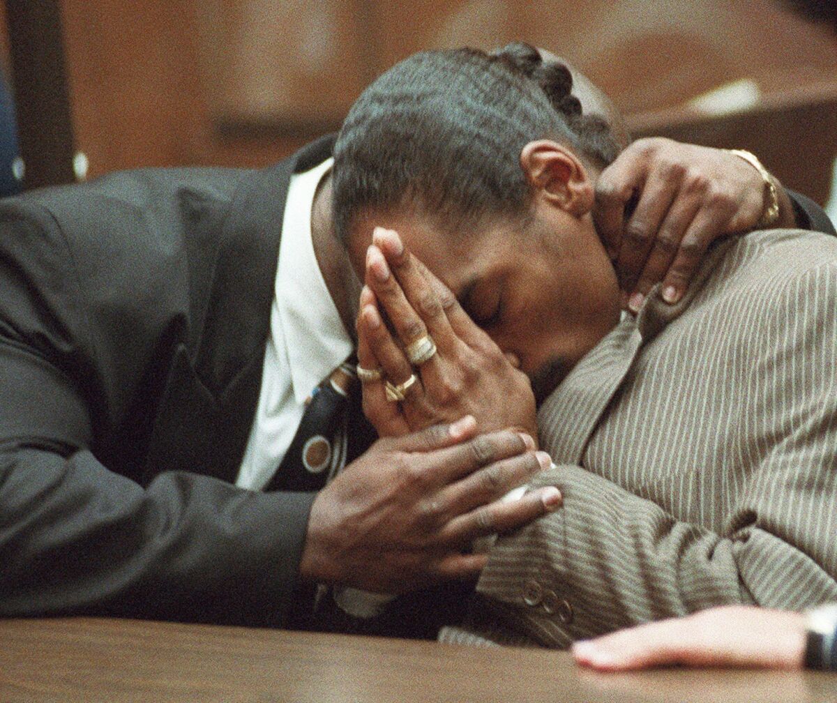 Snoop Dogg, right, is hugged by his bodyguard, McKinley Lee, after the two were acquitted of murder in Los Angeles on Feb. 20, 1996. Snoop’s murder charge happened as the rapper was prepping his seminal debut, “Doggystyle.”