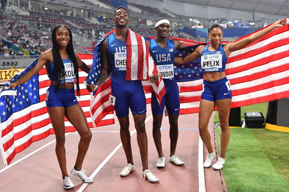 U.S. sprinters Courtney Okolo, Michael Cherry, Wilbert London and Allyson Felix celebrate.