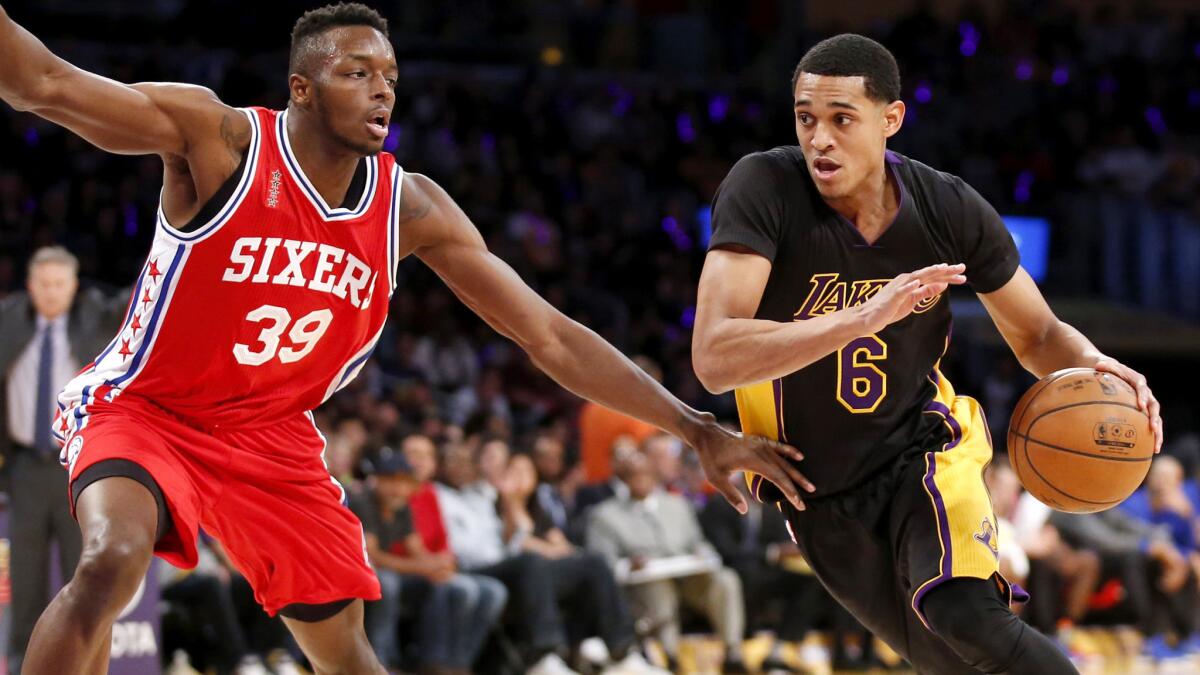 Lakers guard Jordan Clarkson, right, drives down the lane and draws a foul against 76ers forward Jerami Grant in the first half Friday night.