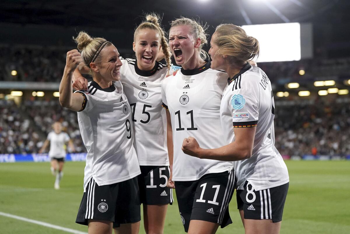 Germany's Alexandra Popp celebrates with teammates after scoring.