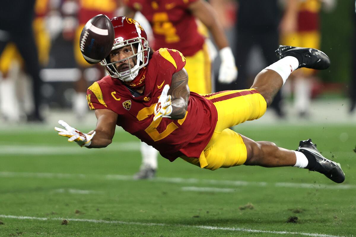 Isaiah Pola-Mao of the USC Trojans intercepts a pass against the UCLA Bruins.
