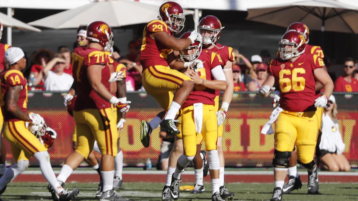 USC teammates celebrate after backup quarterback Matt Fink ran for a touchdown during the fourth quarter.