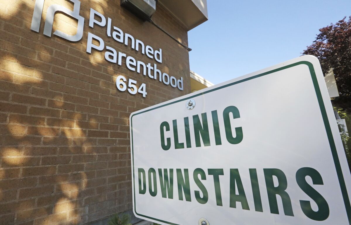 FILE - In this Aug. 21, 2019, file photo, a sign is displayed at Planned Parenthood of Utah in Salt Lake City. The Biden administration is beginning to undo a Trump-era ban on clinics referring women for abortions, a policy directive that led to Planned Parenthood leaving the federal family planning program. (AP Photo/Rick Bowmer)