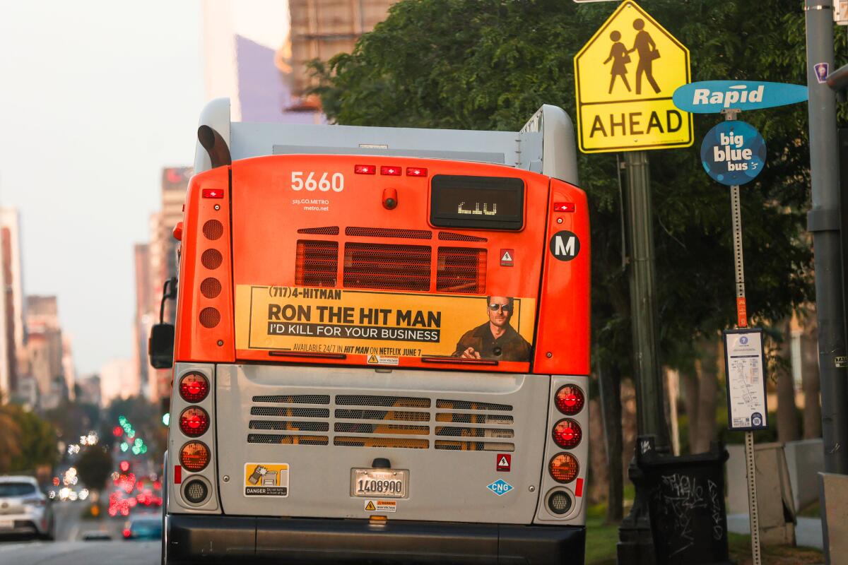 An advertisement on the back of a Metro bus for Netflix's movie "Hit Man."