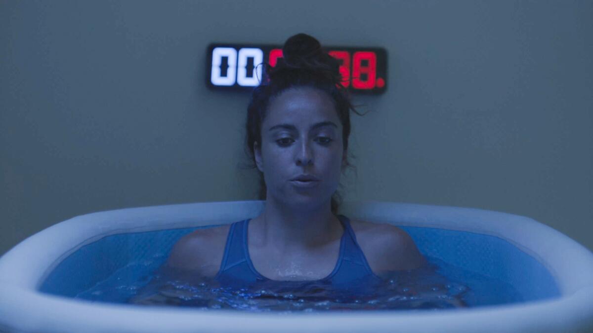 Soccer star Natalie Higgins hits the cold tank as part of her road to recovery from a sidelining knee injury.