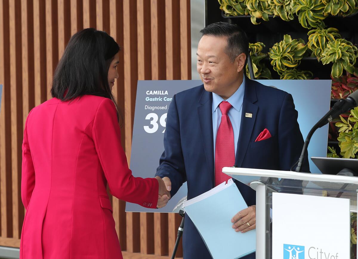 Edward Kim introduces Orange County Health Officer Dr. Regina Chinsio-Kwong during Tuesday's press conference.