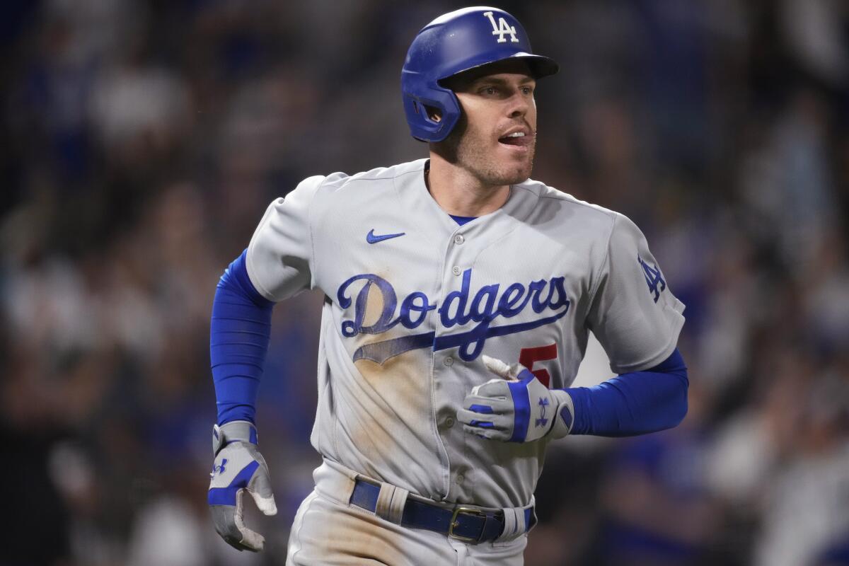 Freeman reaches 100 RBIs and Dodgers beat Rockies 8-2 to near 3rd