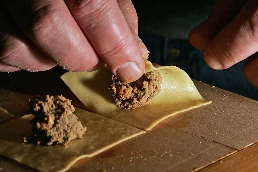 Friedman, Gary –– – 105410.fo.1209.kreplach7.gf Chef Don Dickman folds the dough with filling as he demonstrates how to make kreplach (Jewish ravioli) at a friend's house on 12/9/05.