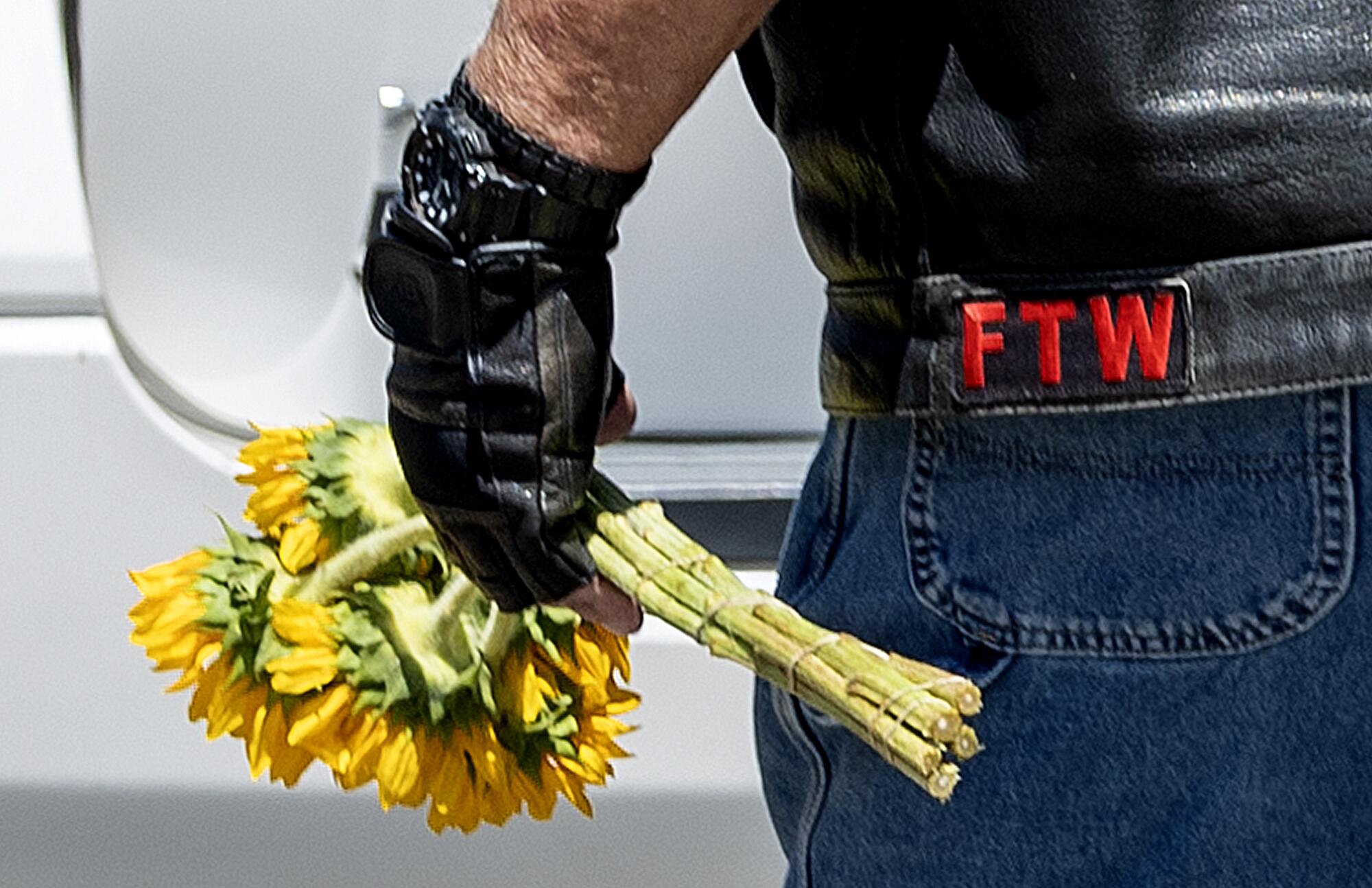 A biker carries a bouquet of flowers.