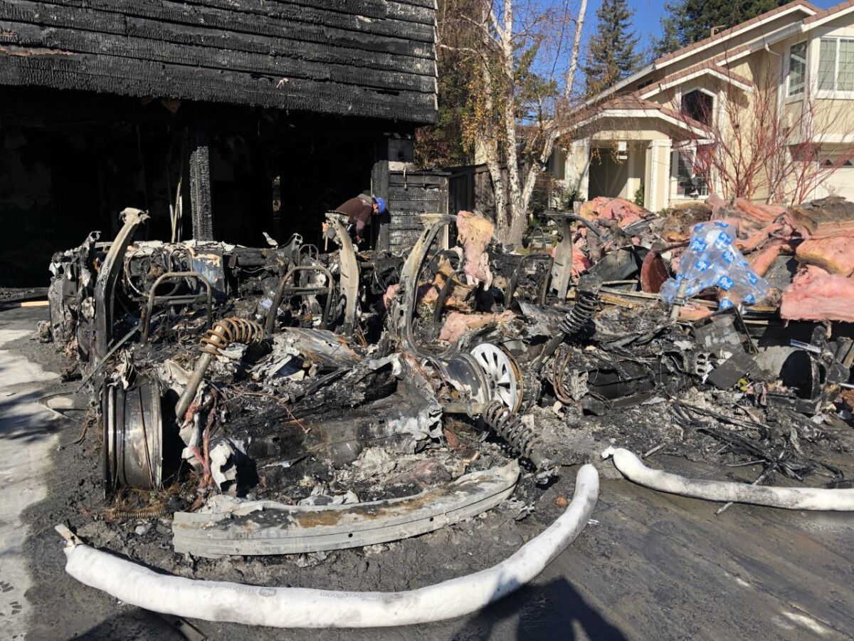 The remains of a pair of Teslas that had been parked in the garage of Jorgen and Carolyn Vindum of San Ramon.